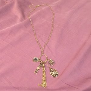Gold chain necklace with accessories that dangle